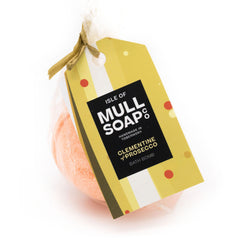 orange coloured round Clementine and Prosecco bath bomb presented as a gift in a bag with coloured tag and bow. Handmade by the Isle of Mull soap co in Tobermory, Scotland. 