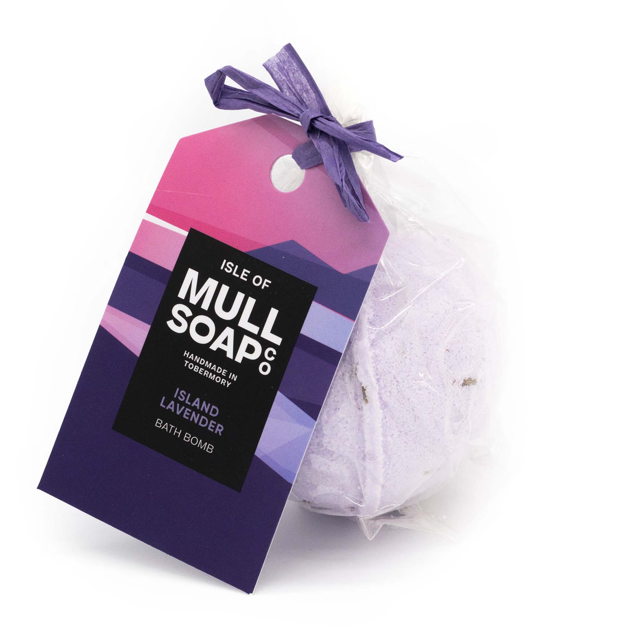 purple coloured round island lavender bath bomb presented as a gift in a bag with coloured tag and bow. decorated with lavender flowers. Handmade by the Isle of Mull soap co in Tobermory, Scotland. 