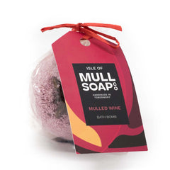 deep red coloured round mulled wine bath bomb presented as a gift in a bag with coloured tag and bow. decorated with a star anise. Handmade by the Isle of Mull soap co in Tobermory, Scotland. 