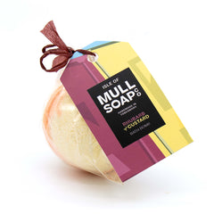 half orange and half yellow round rhubarb and custard bath bomb presented as a gift in a bag with coloured tag and bow. Handmade by the Isle of Mull soap co in Tobermory, Scotland. 