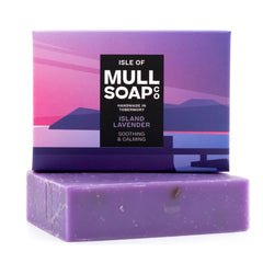 an island lavender soap box sitting on the purple soap bar. The box is a purple seascape design. The soap is described as soothing and calming. Handmade in Tobermory by the Isle of Mull soap co.  