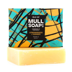 a lemongrass and ginger soap box sitting on the soap bar. The box design is green with yellow buoys and black fishing nets. The soap is described as warm and spicy. Handmade in Tobermory by the Isle of Mull soap co.  