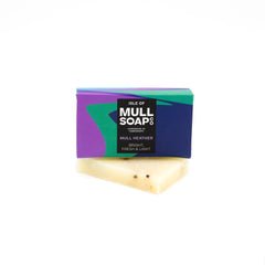 A mull heather mini soap box sitting on a mini soap bar. Soap described as bright, fresh and light. Handmade natural soap made by the isle of mull soap co in Tobermory. 