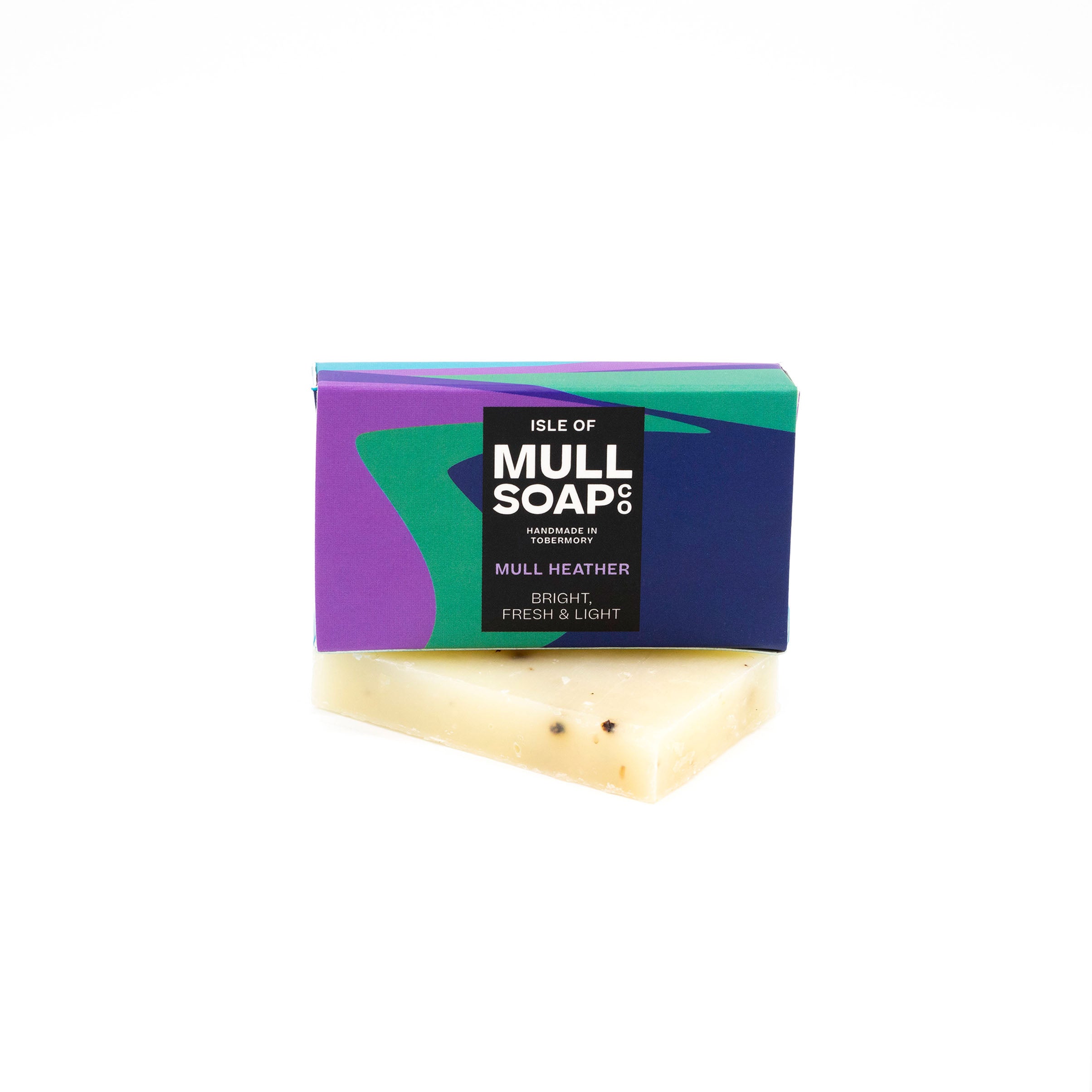 A mull heather mini soap box sitting on a mini soap bar. Soap described as bright, fresh and light. Handmade natural soap made by the isle of mull soap co in Tobermory. 