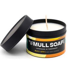 A black tin and lid with colourful yellow and orange label. buzz off insect repellent soy wax candle handmade in Tobermory by the Isle of Mull Soap Co 
