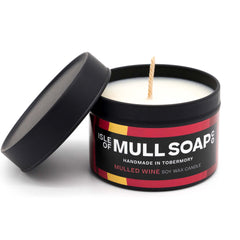 A black tin and lid with colourful red funky label. mulled wine soy candle handmade in Tobermory by the Isle of Mull Soap Co 