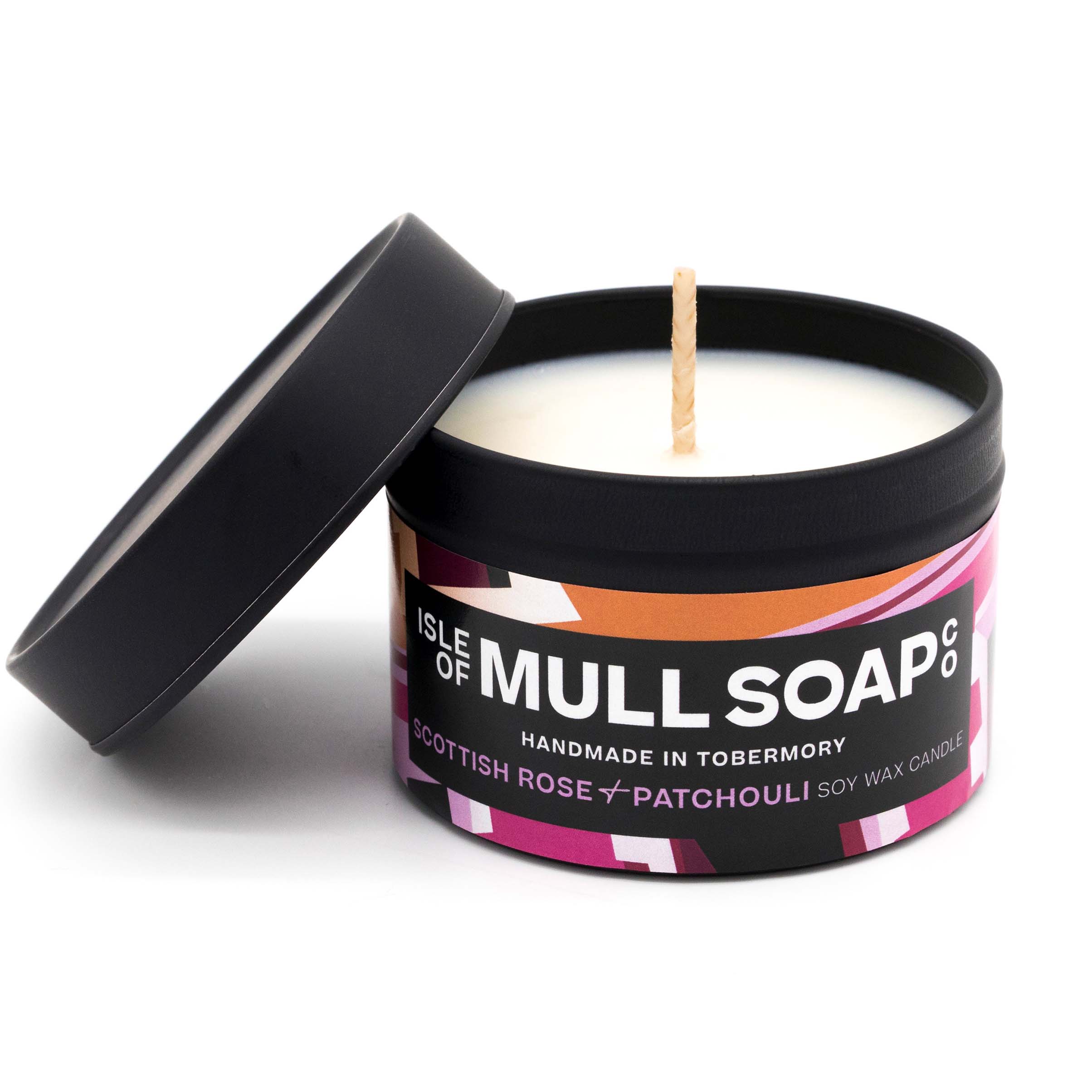 A black tin and lid with pink colourful label. Scottish rose and patchouli soy wax candle handmade in Tobermory by the Isle of Mull Soap Co 